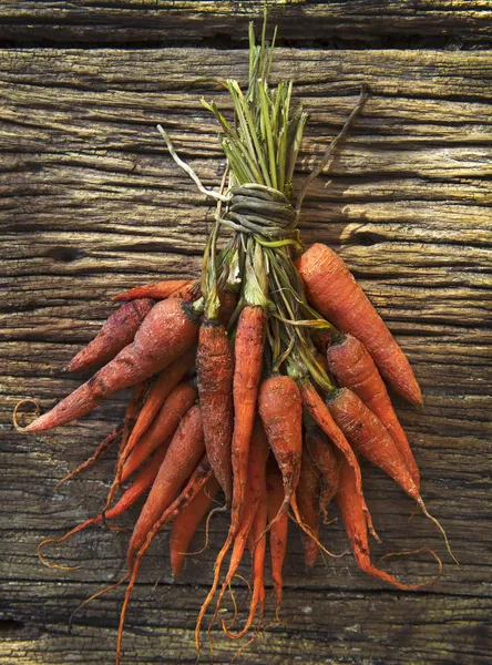 File dry carrot lyinng on old top wood table — Stock Photo, Image