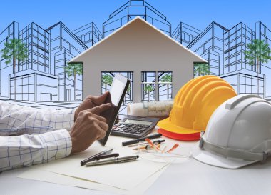 Hand of architect working on computer tablet with construction clipart