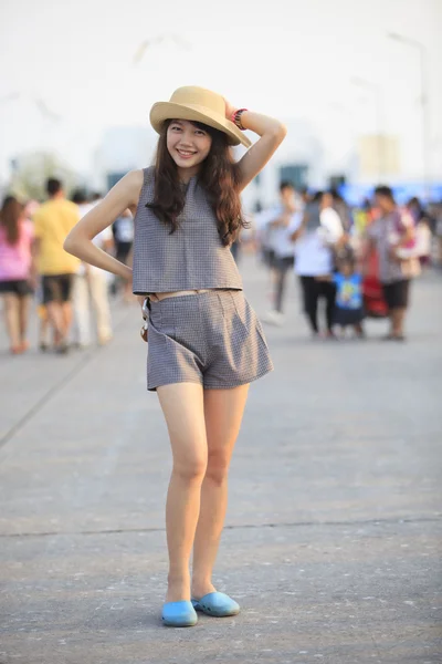 Young asian woman wearing hat standing with crowded — Stock Photo, Image