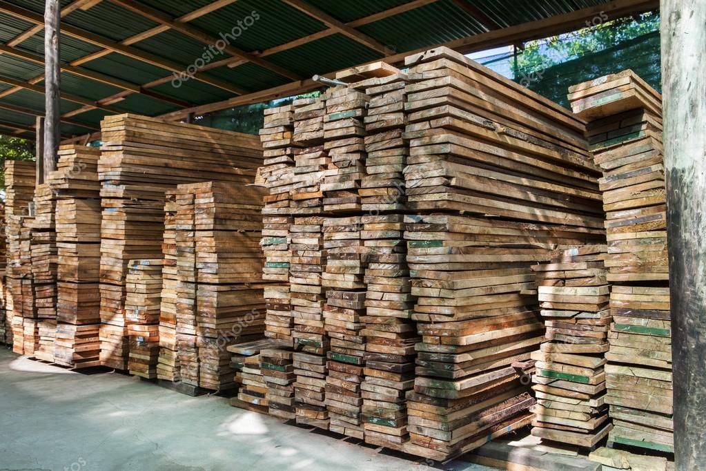Stack of pile wood bar in lumber yard factory use for constructi Stock