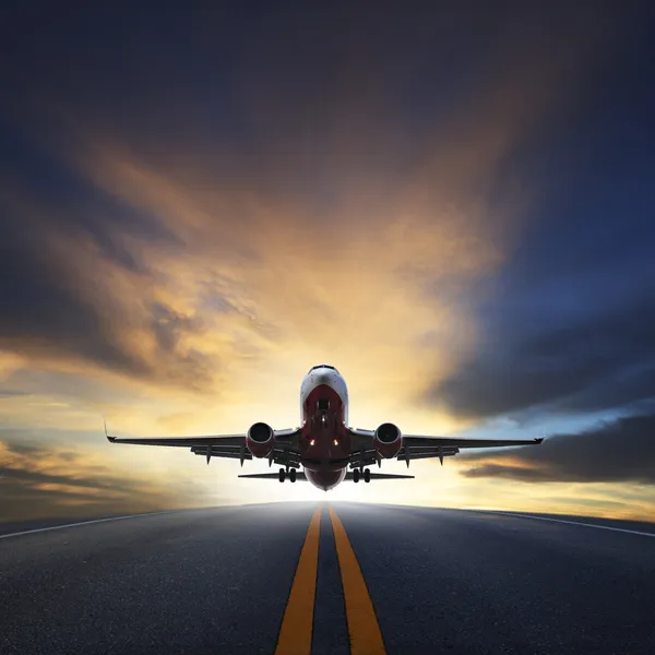 Passenger plane take off from runways against beautiful dusky sk — Stock Photo, Image