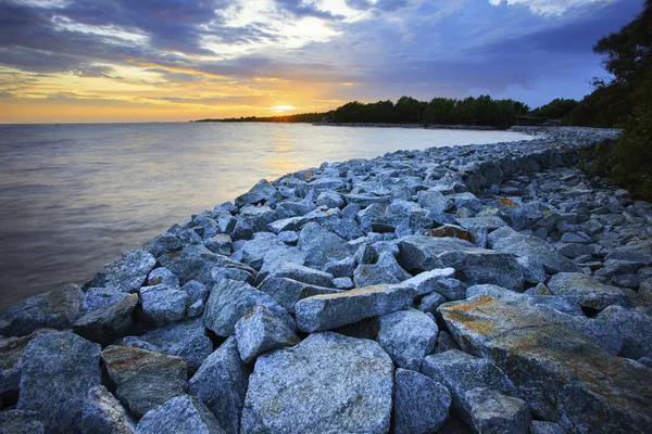 Sun set with rock dam sea coast bank protection perspective line — Stock Photo, Image