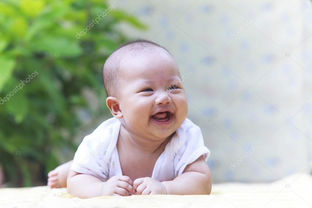 Beautiful photo close up face of adorable new born baby smiling