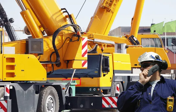 Ingeniero con grandes grúas móviles de construcción —  Fotos de Stock