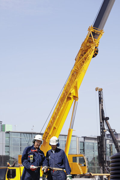 mobile construction crane and workers