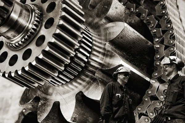 Steel workers and gears machinery — Stock Photo, Image