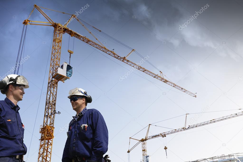 building workers, cranes and construction