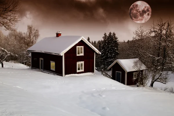 Red moon rise over old cottages