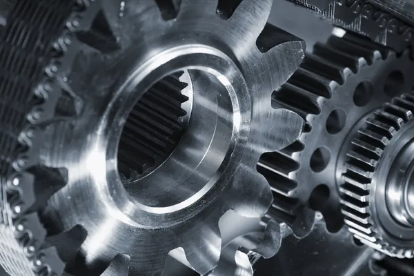 Gears and cogs in titanium and steel — Stock Photo, Image
