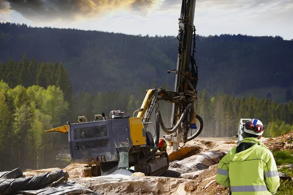 Industrial rock blasting machines with surveying instrument — Stock Photo, Image