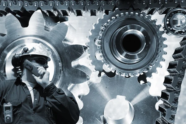 Engineer with large titanium gears machinery — Stock Photo, Image