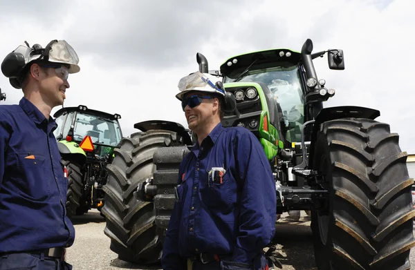 Giant farming tractors and mechanics Stock Image