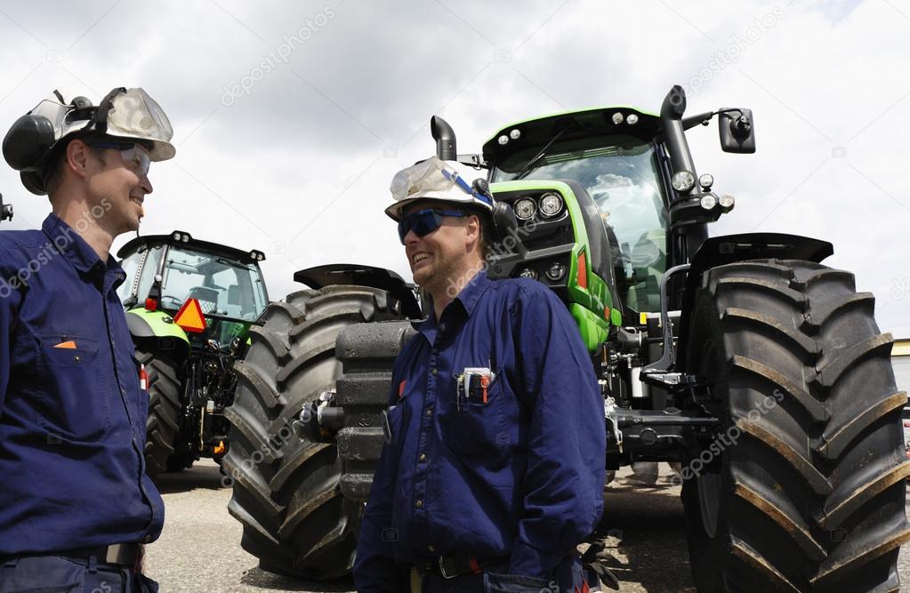 Giant farming tractors and mechanics