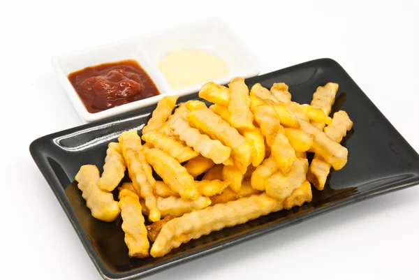 Frites dans une assiette noire — Photo