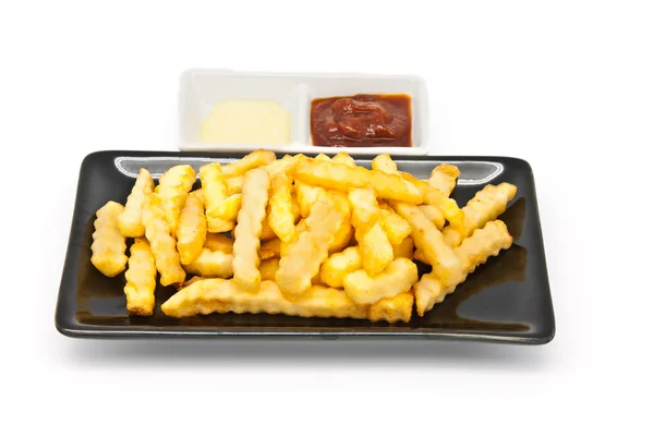 Frites dans une assiette noire — Photo