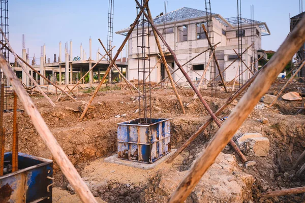 Construction of reinforced concrete foundation with piles to support building weight at site