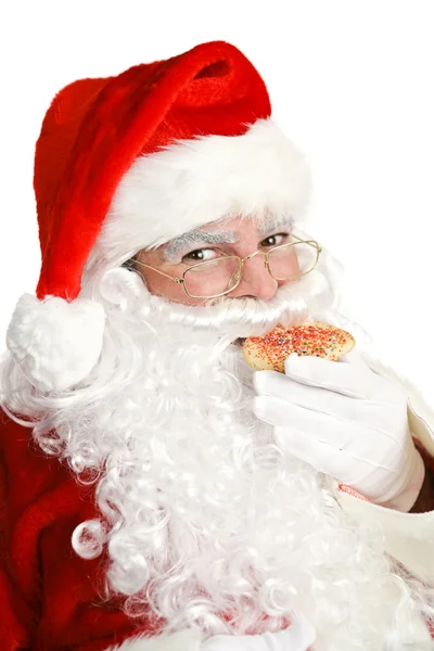 Санта-Клаус ест рождественское печенье — стоковое фото