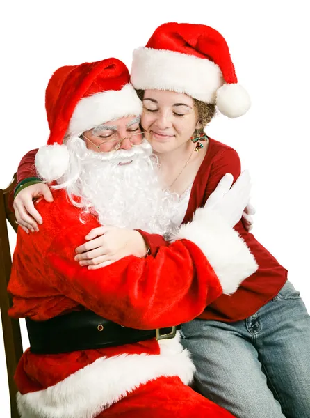 Chica sentada en la vuelta de Santas recibiendo un abrazo —  Fotos de Stock