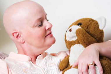 Cancer Patient Comforted by Teddy Bear clipart