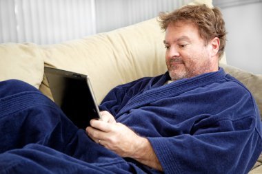 Casual Man Using Tablet PC clipart