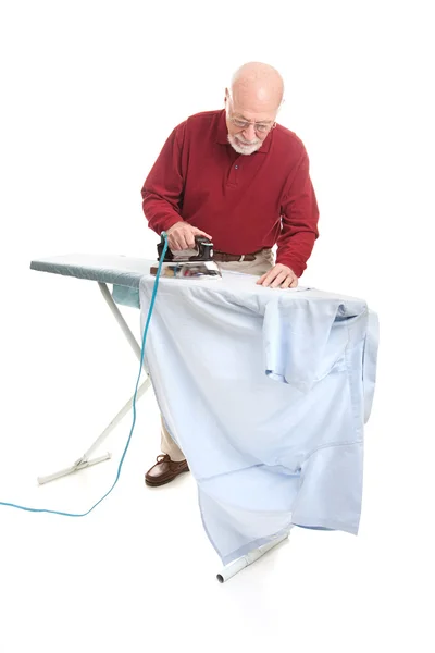 Senior mannen irons skjortan — Stockfoto