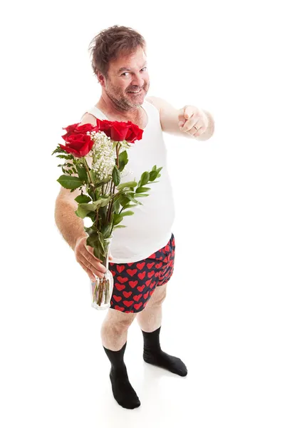 Övermodig tilltufsad kille med blommor — Stockfoto