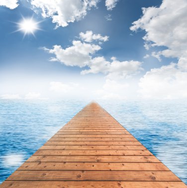 Wooden bridge with cloudy blue sky and the blue sea clipart