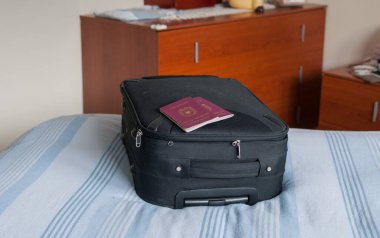 suitcase on the bed and passports