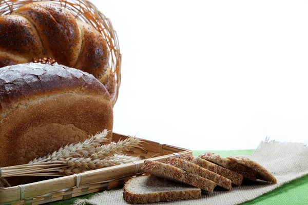 Fresh bread with ears of wheat on the canvas. — Stock Photo, Image