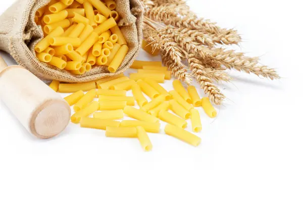 Pasta in a canvas bag and ear on white background. — Stock Photo, Image