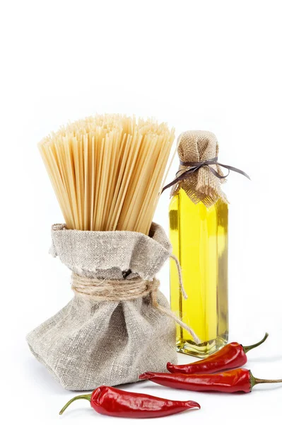 Pasta, red pepper and olive oil on white background. — Stock Photo, Image