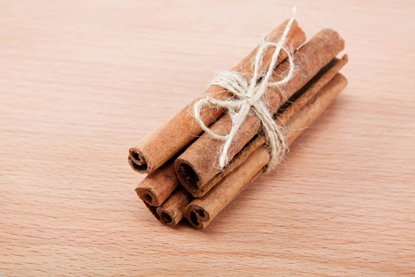 Cinnamon isolated on a wooden background. — Stock Photo, Image