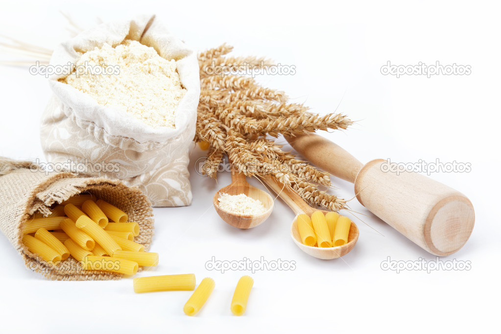 Flour in a canvas bag and ear on white background.