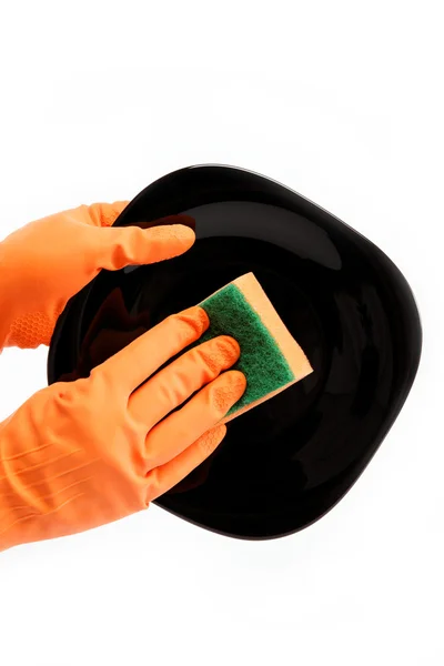 Hands in rubber gloves can sponge the plate on a white backgroun — Stock Photo, Image