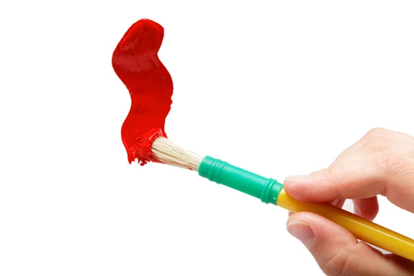 Female hand painting brush with red paint, isolated over white. — Stock Photo, Image