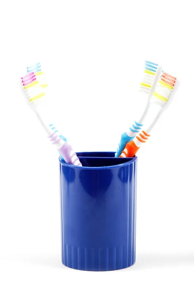 Toothbrushes in cup, isolated on white background — Stock Photo, Image