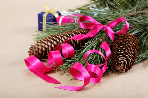 Decorações de Natal. Ramo de abeto com cones, fita rosa e — Fotografia de Stock