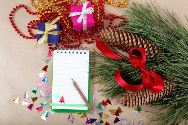 Christmas decorations, gifts and a notebook for congratulations. — Stock Photo, Image