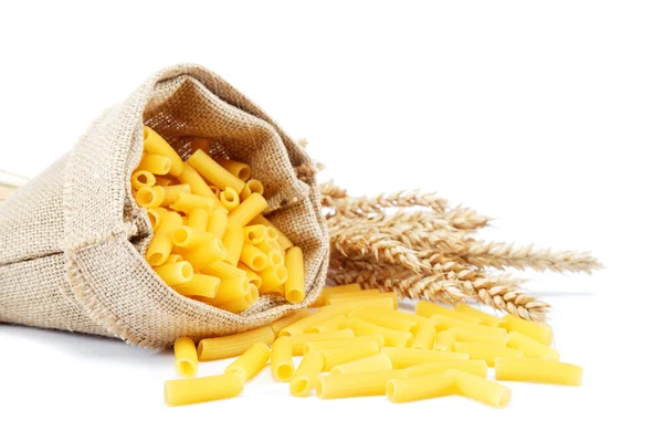 Pasta in a canvas bag and ear on white background. — Stock Photo, Image