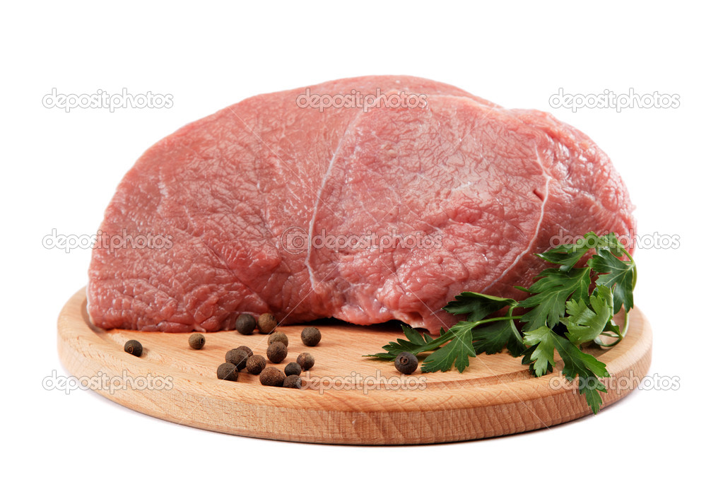 Raw meat and spices on a wooden cutting board isolated on white