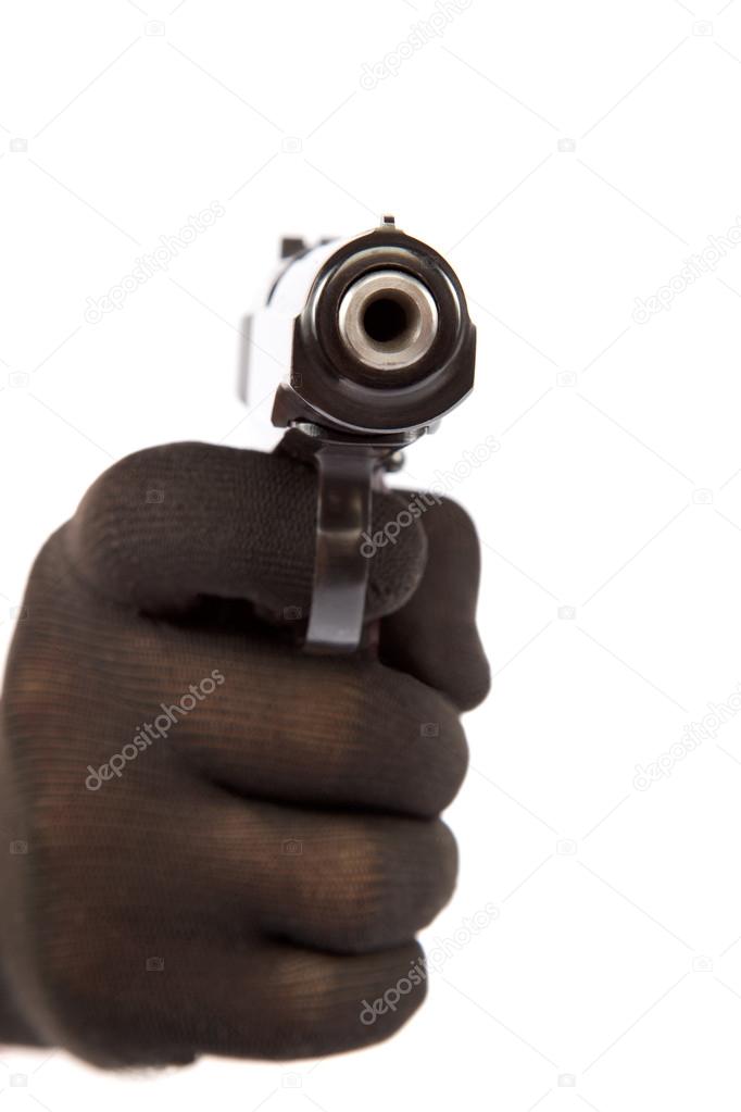 Hand in black glove holding a gun on a white background.