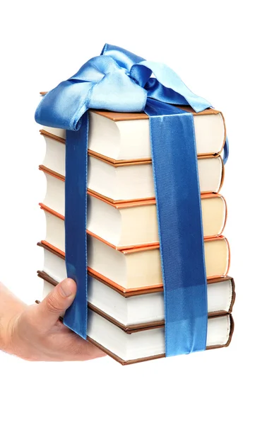 Книжка як подарунок. Стек книг у жіночій руці на білому фоні — стокове фото