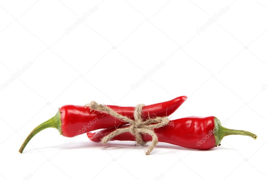 Red hot chili peppers tied with rope isolated on white backgroun