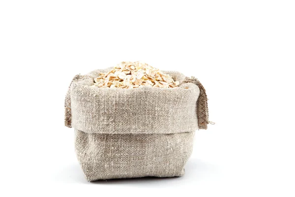 Rolled oats in a canvas bag isolated on white background. — Stock Photo, Image