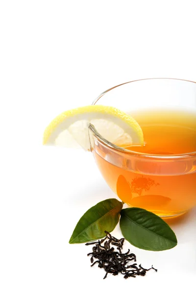 Glass cup of tea with a slice of lemon on a white background. — Stock Photo, Image