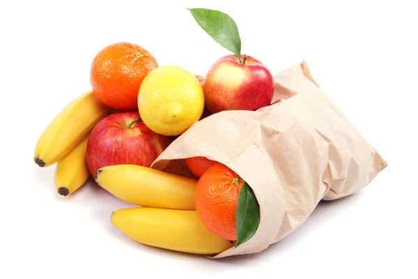 Свежие фрукты в бумажном пакете на белом фоне . — стоковое фото