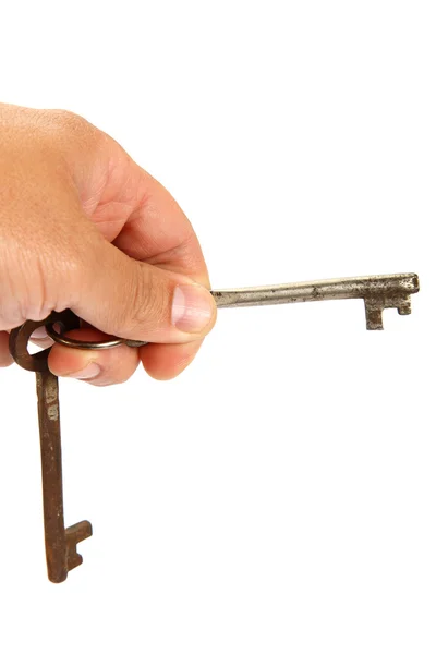 Två gamla nycklar i hand isolerad på en vit bakgrund. — Stockfoto