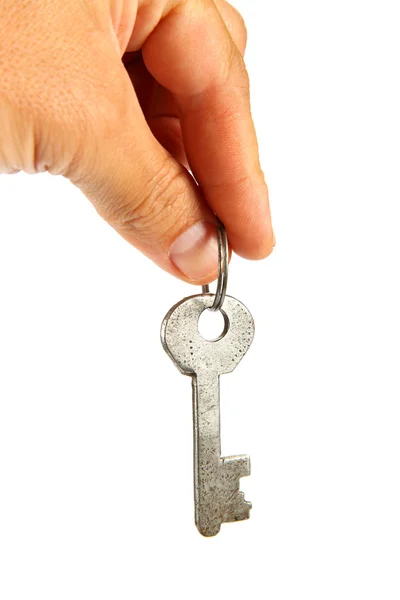Gammal nyckel i hand isolerad på en vit bakgrund. — Stockfoto