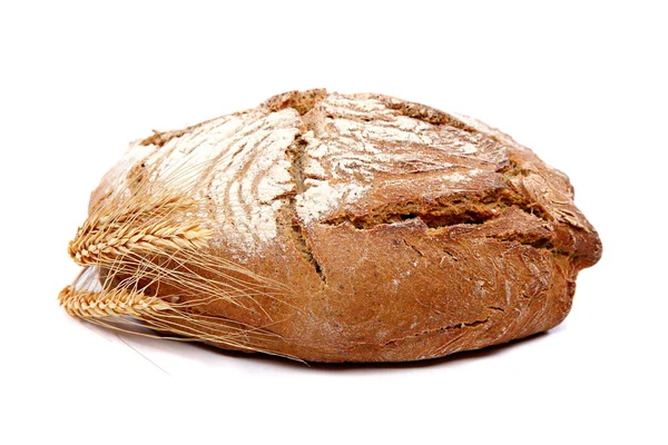 Loaf of rye bread and wheat ears. — Stock Photo, Image