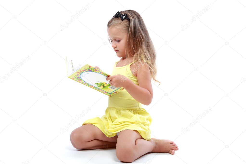 Cute little girl with an open book.